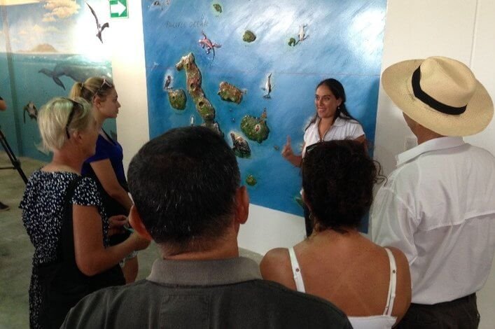 Visitors to the Charles Darwin Exhibition Hall, hear a talk about the marine biodiversity in the Galapagos.