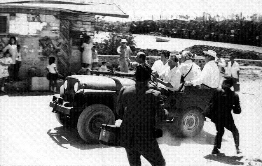 Peter Kramer driving Prince Philip through the streets of Puerto Ayora, 1970.