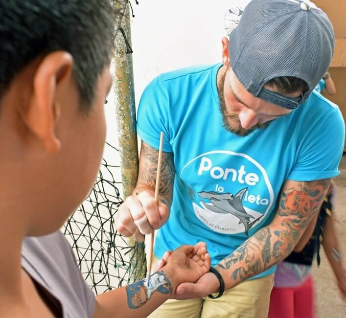 Shark tattoo painting at Miraflores Market in Puerto Ayora.